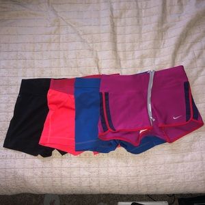 FOUR pairs of nike pro exercise shorts